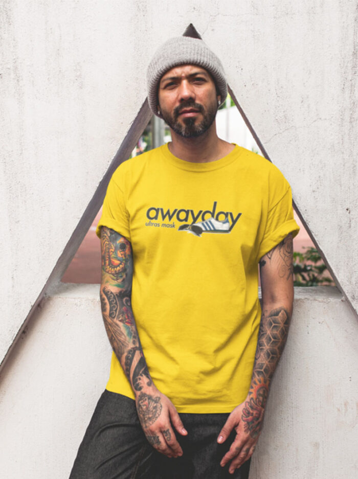 0007 tattooed man wearing a t shirt mockup while lying against a triangle structure a16986 2 1024x768 1