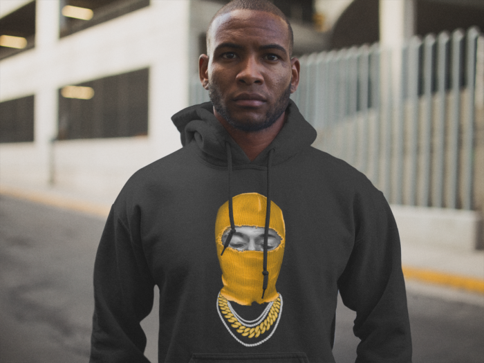 serious young black man wearing a pullover hoodie out in the street a12564 1