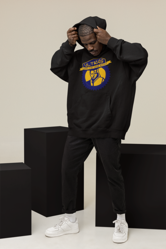 hoodie mockup featuring a man posing at a studio with colorful cubes m26650 2